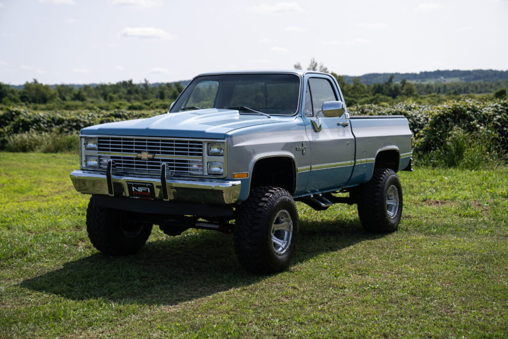 Blue 1984 K10 parked in a green field
