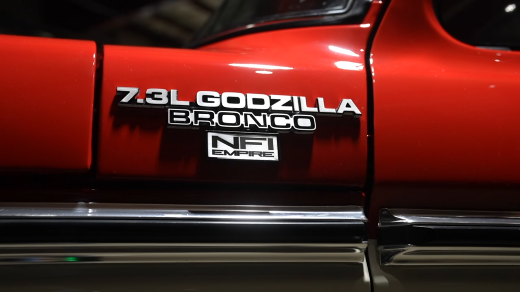 1978 Ford Bronco featuring custom '7.3L Godzilla Bronco' and 'NFI Empire' badges, showcasing the vehicle's restomod transformation.