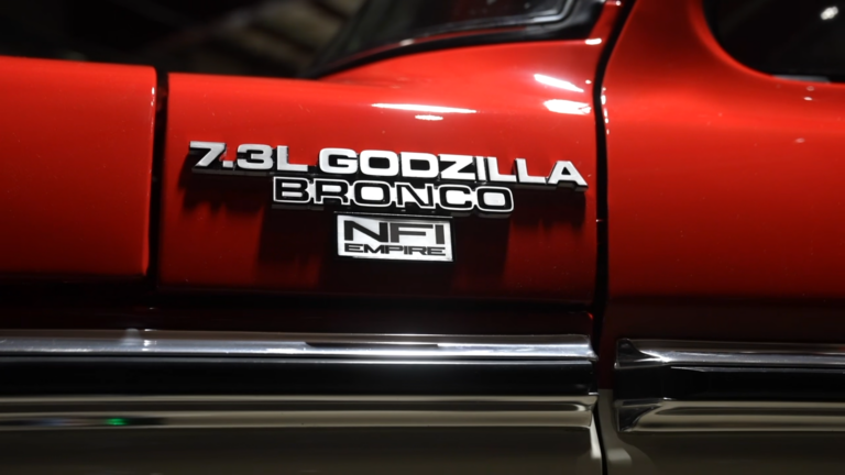 1978 Ford Bronco featuring custom '7.3L Godzilla Bronco' and 'NFI Empire' badges, showcasing the vehicle's restomod transformation.